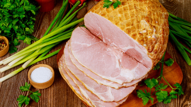 Whole ham being sliced 