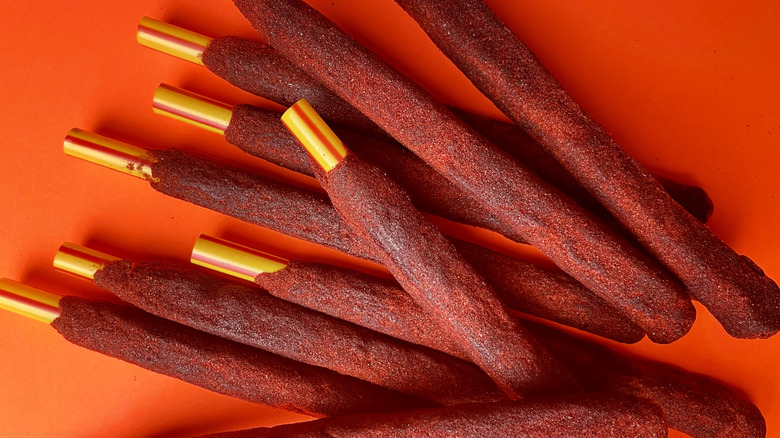 Banderillas sticks, made with tamarind pulp and chili powder on large yellow straws