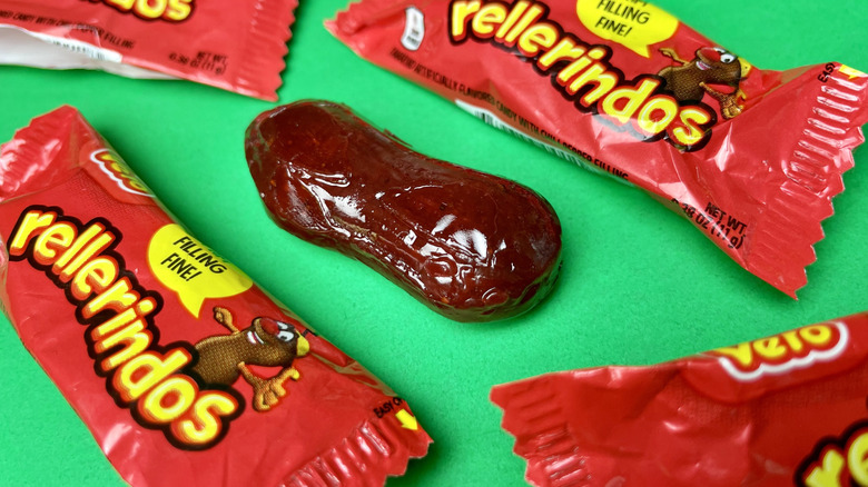 A pieces of rellerindos candy surrounded by wrapped candies