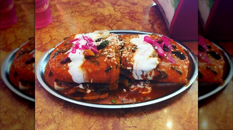 Two stuffed tortillas from Xalos Mexican Grill, topped with crema and crumbled cheese