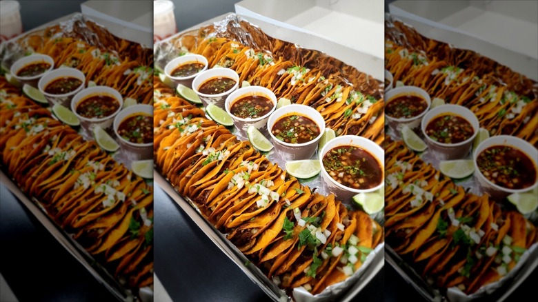 Rows of tacos and sauce from La Birria