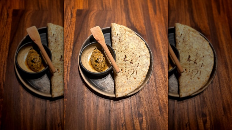 Bread service on plate with wooden spoon at Acamaya