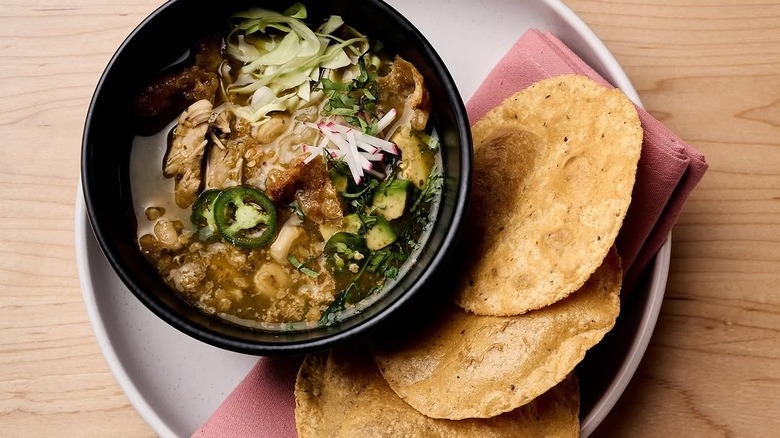 a hearty bowl of Mexican food with hard shell tortillas
