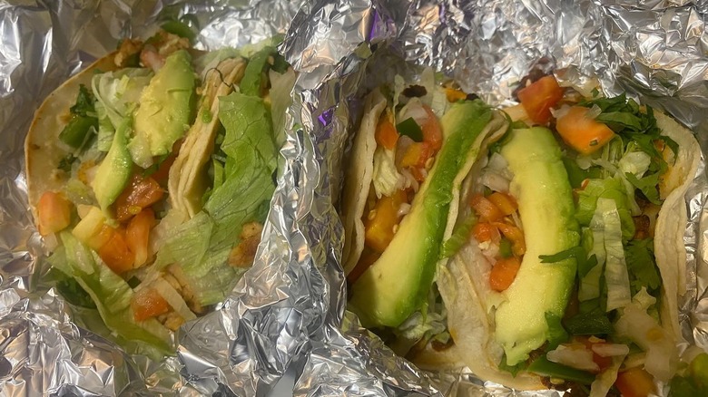 vegetarian tacos with soy curls and soyrizo in aluminum foil