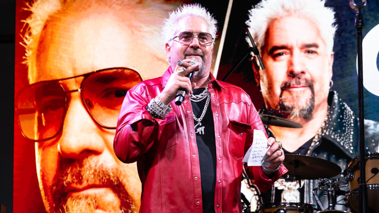 Guy Fieri on stage at an event