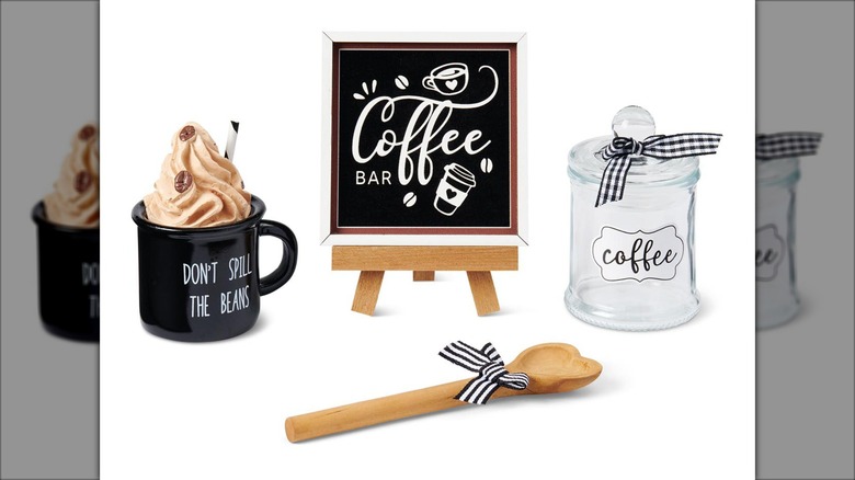 coffee cup, small easel sign, wood spoon, and glass jar against white background