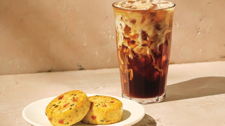 Starbucks coffee and Italian Sausage Egg Bites on a white plate