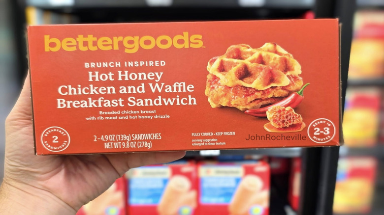 Hand holding bettergoods chicken waffle sandwich