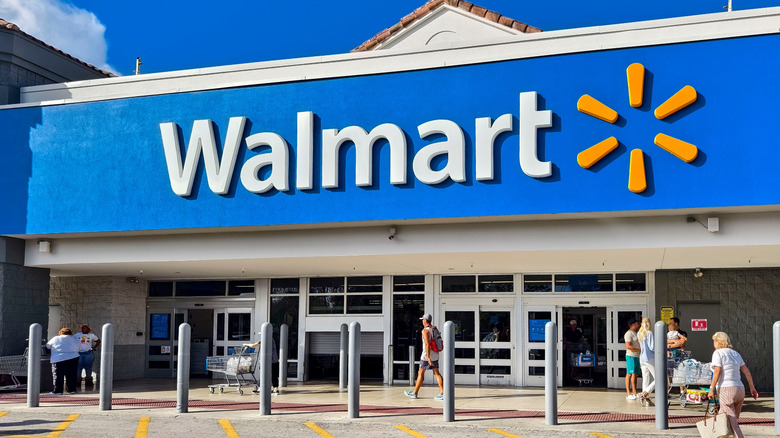 The outside of a Walmart store with customers outside