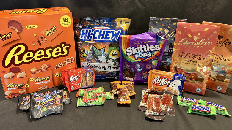 variety of Halloween candy packages on black background