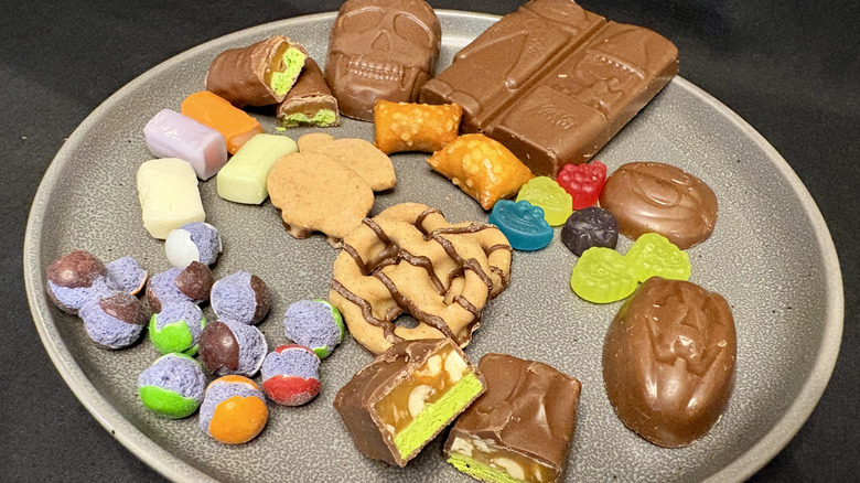 variety of Halloween candies and treats on gray plate
