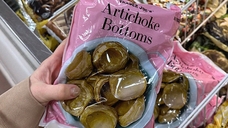 hand holding Artichoke Bottoms bag in Trader Joe's freezer aisle