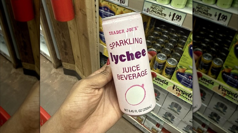 hand holding can of lychee beverage