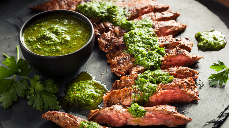 skirt steak with chimichurri on black stone