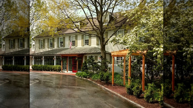 Road and exterior of cream General Warren Inne building