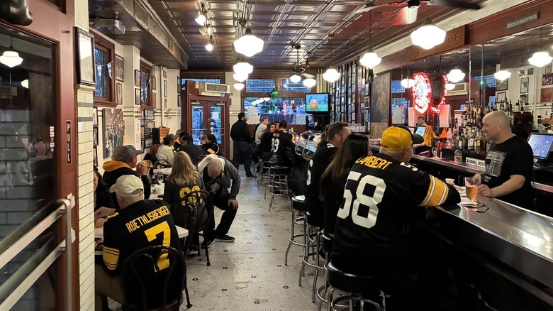Diners at oyster house sit at long bar