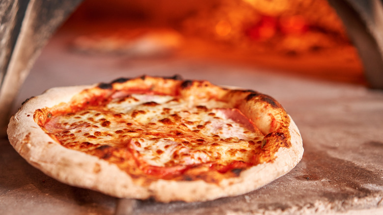 Pizza baking in pizza oven