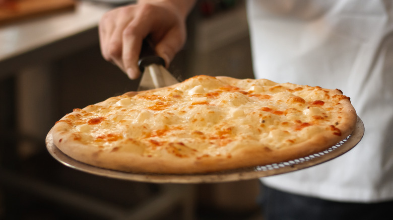 chef holding pizza peel 