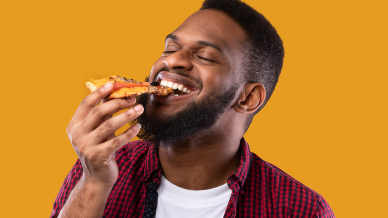 man eating pizza