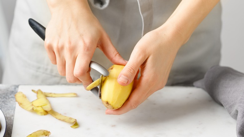 woman peeling potato