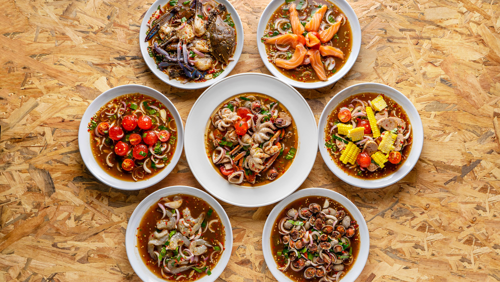 spicy bowls of seafood soup with salmon, squid and shrimp