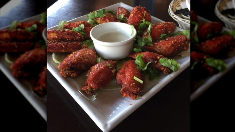 a plate of spicy garlic wings
