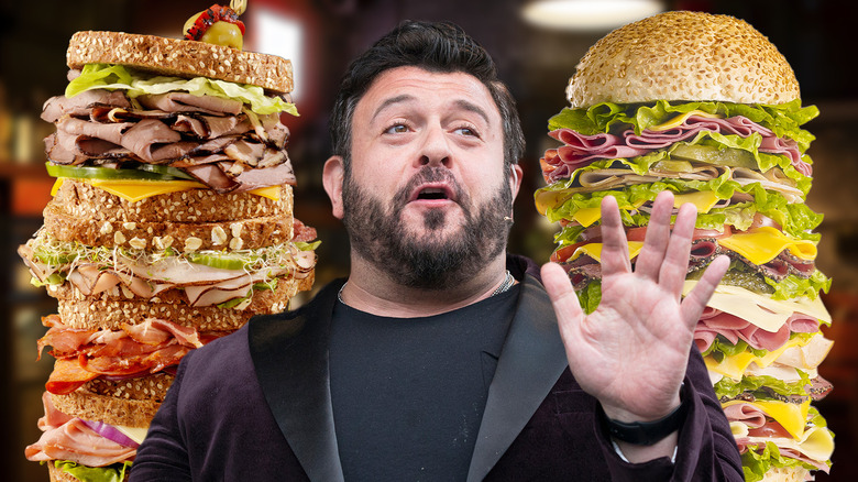 Adam Richman between two sandwiches