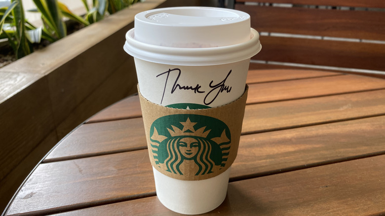 Starbucks cup with "Thank You" written in black marker.