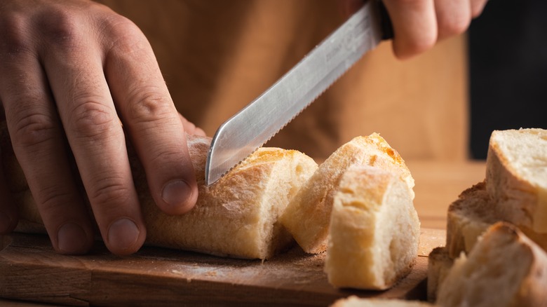 Man cutting bread