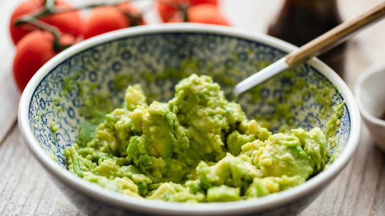 Mashed up avocado in decorative bowl