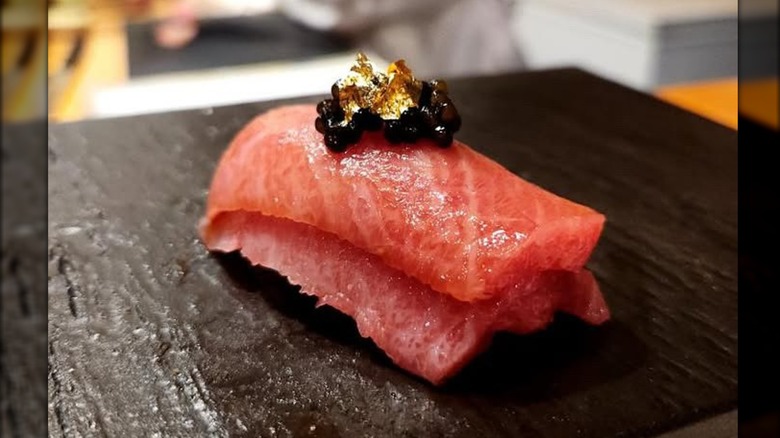 Red salmon nigiri with caviar on top
