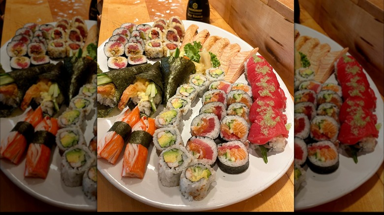 Sushi tray with 6 different sushi rolls, with avocado, shrimp, tuna, and salmon, as well as 3 temakis, crab nigiri and salmon nigiri