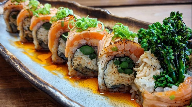 Vegetarian kobayashi maru sushi roll, with house smoked salmon, broccolini, spicy crab, cilantro, shallot, ponzu, and rayu