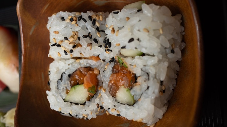 Sushi rolls dusted with sesame seeds
