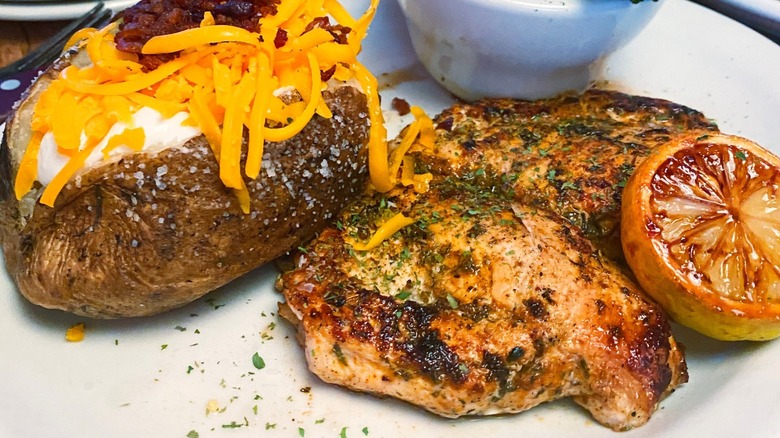 herb crusted chicken with baked potato from Texas Roadhouse