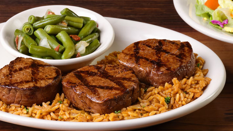 Filet medallions on rice with side of beans at Texas Roadhouse