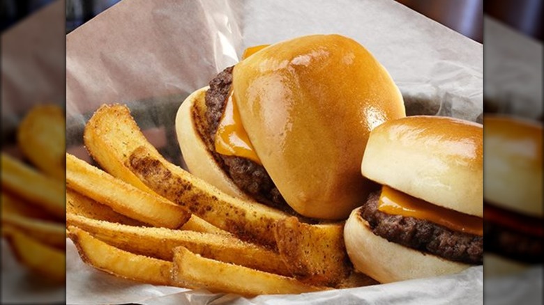 Two burgers and some fries are in a basket at Texas Roadhouse