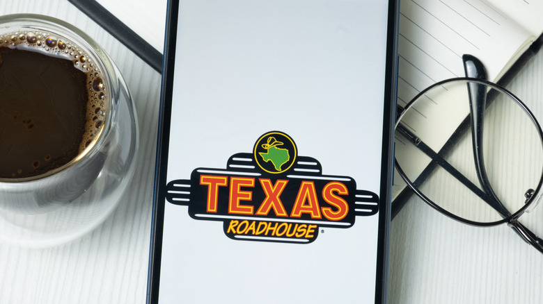 Texas Roadhouse logo on phone screen