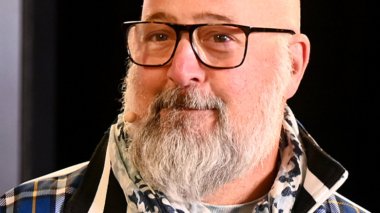 Andrew Zimmern in black glasses