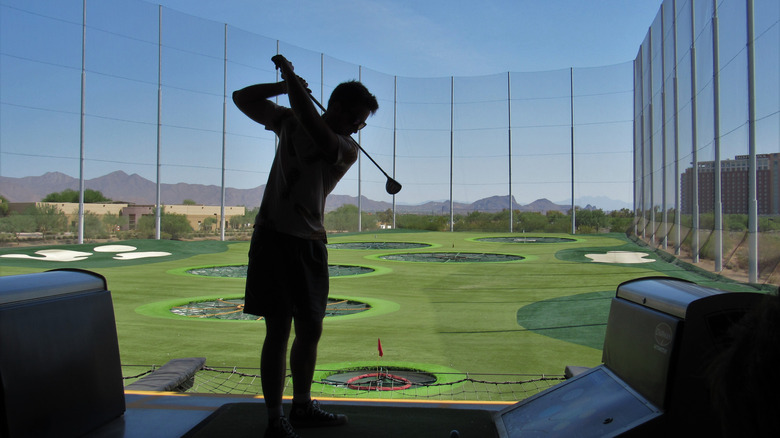 Topgolf customer swinging club