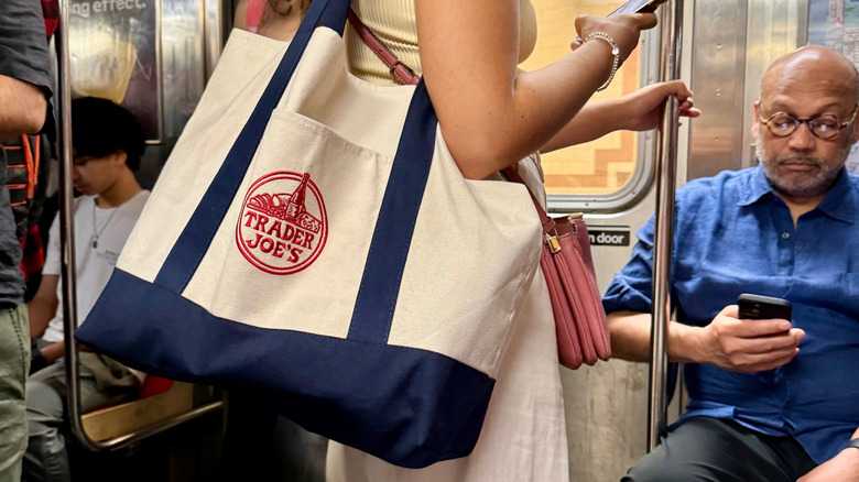 A Trader Joe's cloth bag on a subway