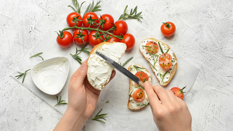 Person applying spread to bread