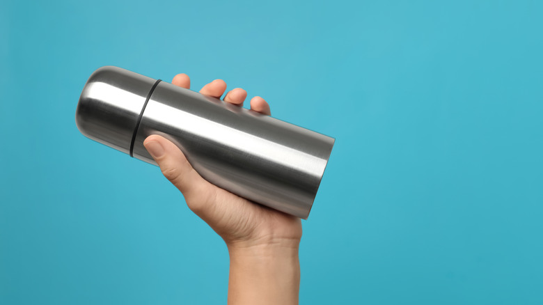 Travel mug on blue background