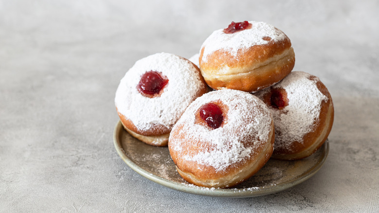 a plate of jelly-filled donuts 