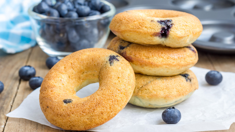 blueberry cake donuts with blueberries around them