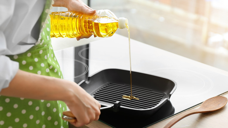 pouring oil into frying pan