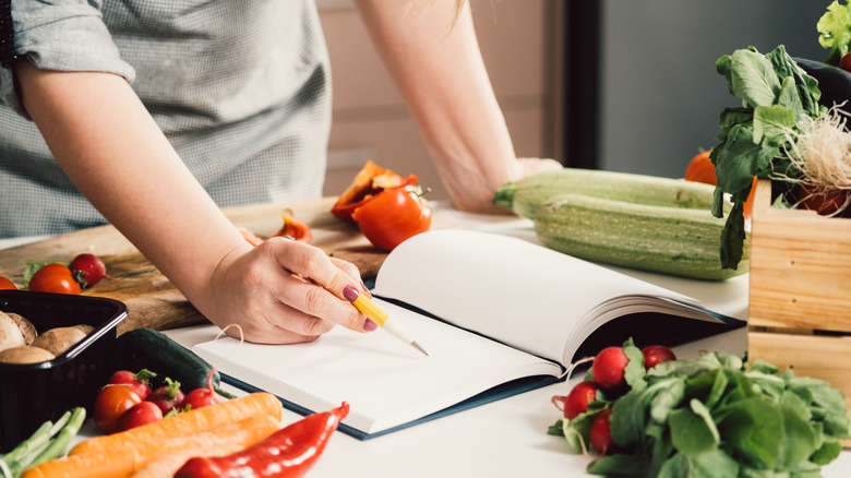 book surrounded by vegetables