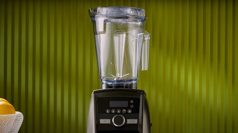 Vitamix blender near green background