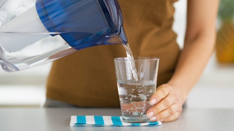 Pouring from water filter pitcher