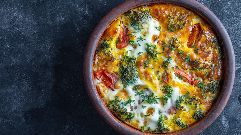 Egg frittata in bowl on slate table